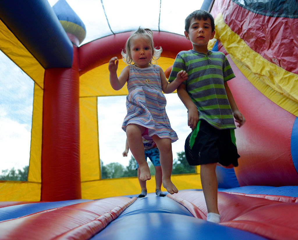 Nora Kilgore, 2, and Miles Haefling, 6, play in a bounce house